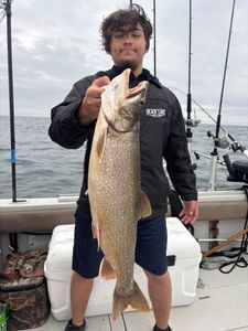 A person fishing for a lake trout in NY