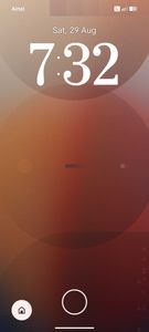Phone lock screen showing time 7:32 on Saturday August 29th with abstract red gradient background