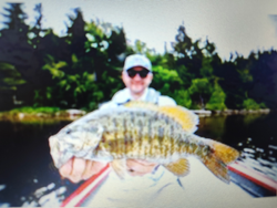 Nice smallmouth bass caught using deep sea jigging techniques in clear conditions.