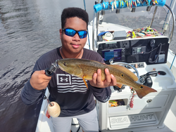 Light tackle triumph: Redfish hooked under partly cloudy skies in New Bern!