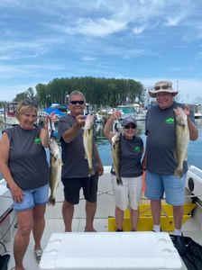 4 people fishing in OH, holding their catch