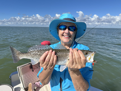 Nice speckled trout using light tackle and drift fishing techniques in clear conditions.