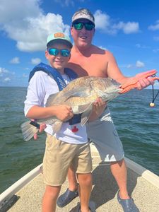 Three people fishing in Cocodrie