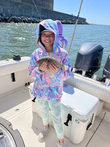 Fisherman catches a summer flounder in the ocean at Ocean Springs