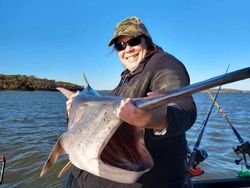 Angler fishing at sandy location in Sand Springs
