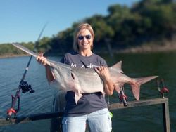 A person fishing on the sand in Sand Springs