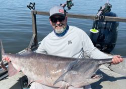 A lone fisherman casting a line in the sand at Sand Springs