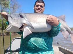 A lone fisherman reeling in their catch in OK