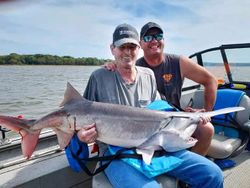 Two people fishing with one small fish in OK location