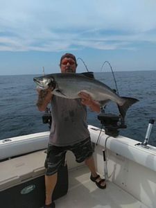 One fisherman stands in water with fishing rod in NY