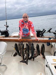 A fisherman holding a basket of 5 rainbow trout in Mexico