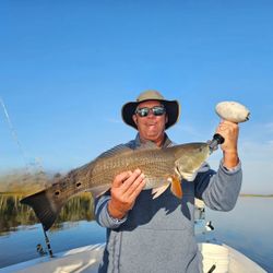 A person fishing for a redfish in Florida