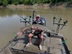 Alligator gar catch displayed on fishing platform with multiple rod holders in Cayuga TX