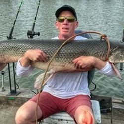 Angler holding big fish in Cayuga
