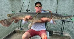Large alligator gar caught while fishing in Cayuga TX displayed on boat with fishing rods
