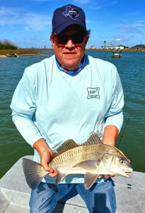 Photograph of a 12-inch black drum fish caught while fishing in Port Aransas