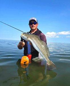 Proud angler with a large rainbow trout caught in Port Aransas