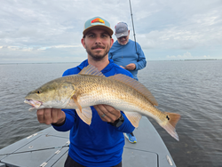 Big redfish reeled in during a partly cloudy day with light tackle!