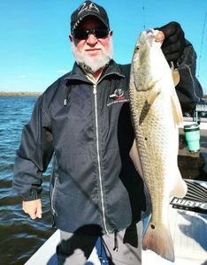 A fisherman with a large redfish in Port Aransas