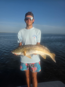 Huge 22-inch Redfish reeled in during a stormy Port Aransas adventure!