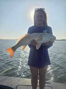 Reeled in a keeper on the water's edge.