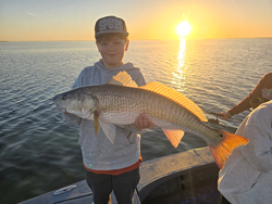 Sunset on the water with a nice catch.