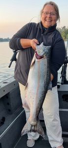 A fisherman catching a Chinook Salmon in Granite Bay