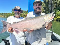 A fisherman holding a Chinook Salmon in Granite Bay