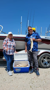 Two people fishing by the lakeside in Marblehead