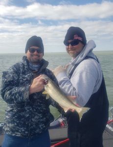 Two people fishing at the lakeside in Marblehead