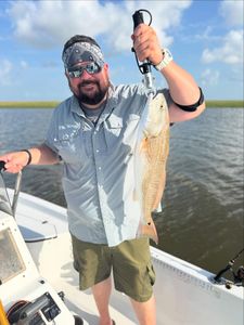 A fisherman reeling in a 17-inch catch in TX