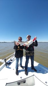 Two anglers enjoying a successful fishing trip in League City