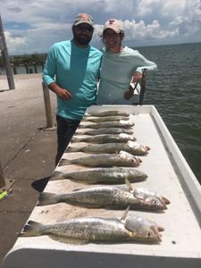 2 people fishing with 3 big fish in TX