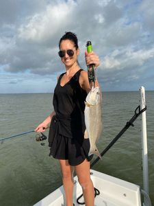 A lone angler holding a fishing rod in Texas
