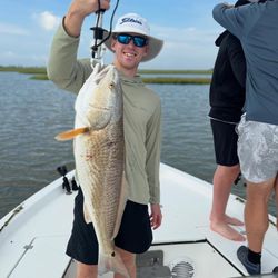 Fisherman catching redfish in TX