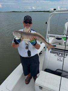 Angler holding a red redfish caught in TX