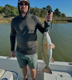 A lone fisherman reeling in a catch in TX