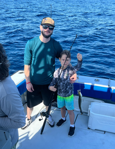 Fishing trip with American Eel catch on boat deck over blue ocean water
