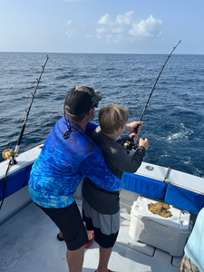 Deep sea fishing scene with fishing rods set up on boat deck over blue ocean water