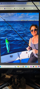 Deep sea fishing scene with fishing rod and caught fish on boat deck with ocean and city skyline in background