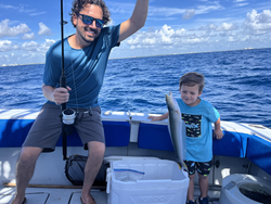 Fishing boat on ocean with freshly caught fish displayed in cooler