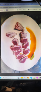 Fresh caught fish fillets arranged on white plate with orange sauce