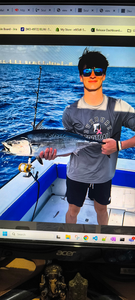 Reeling in a Little Tunny under stormy skies at Riviera Beach!