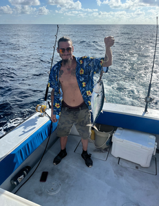 Reeling in a 16-inch Little Tunny under partly cloudy skies!