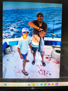 Successful fishing trip showing caught fish on boat deck with fishing equipment