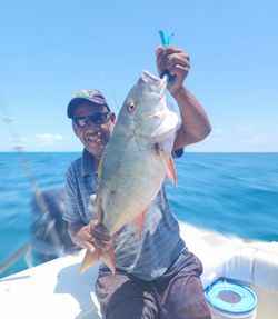 Angler with fishing rod enjoying water sports in FL