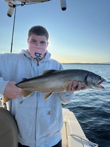 A person fishing for a lake trout in NY