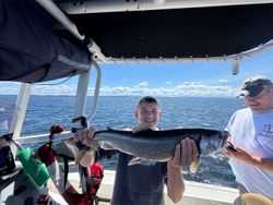 Fisherman catching lake trout at Cumberland Head