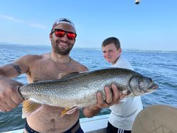 Angler holding a large lake trout in New York