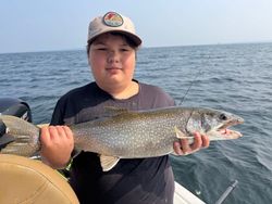 A person fishing for a lake trout in NY